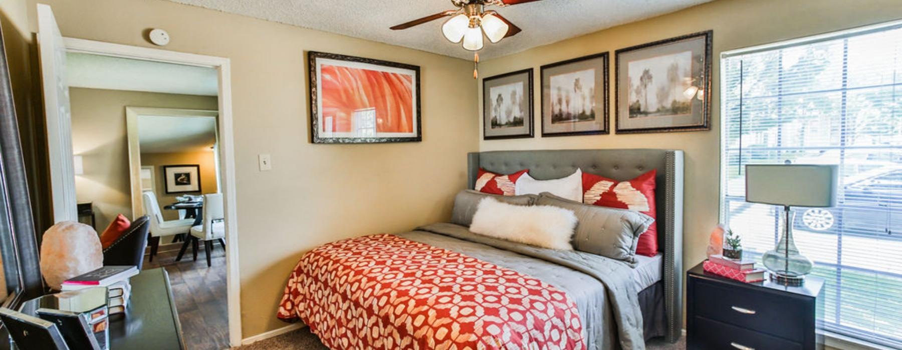 a bedroom with a fan and a bed